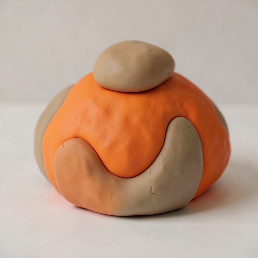 Soft clay-model portrait of a rounded figure in pale yellow-green and black, calm and friendly.
